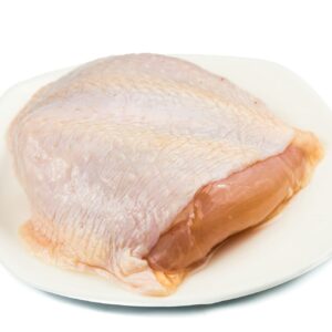 Fresh chicken breast meat with skin on plate